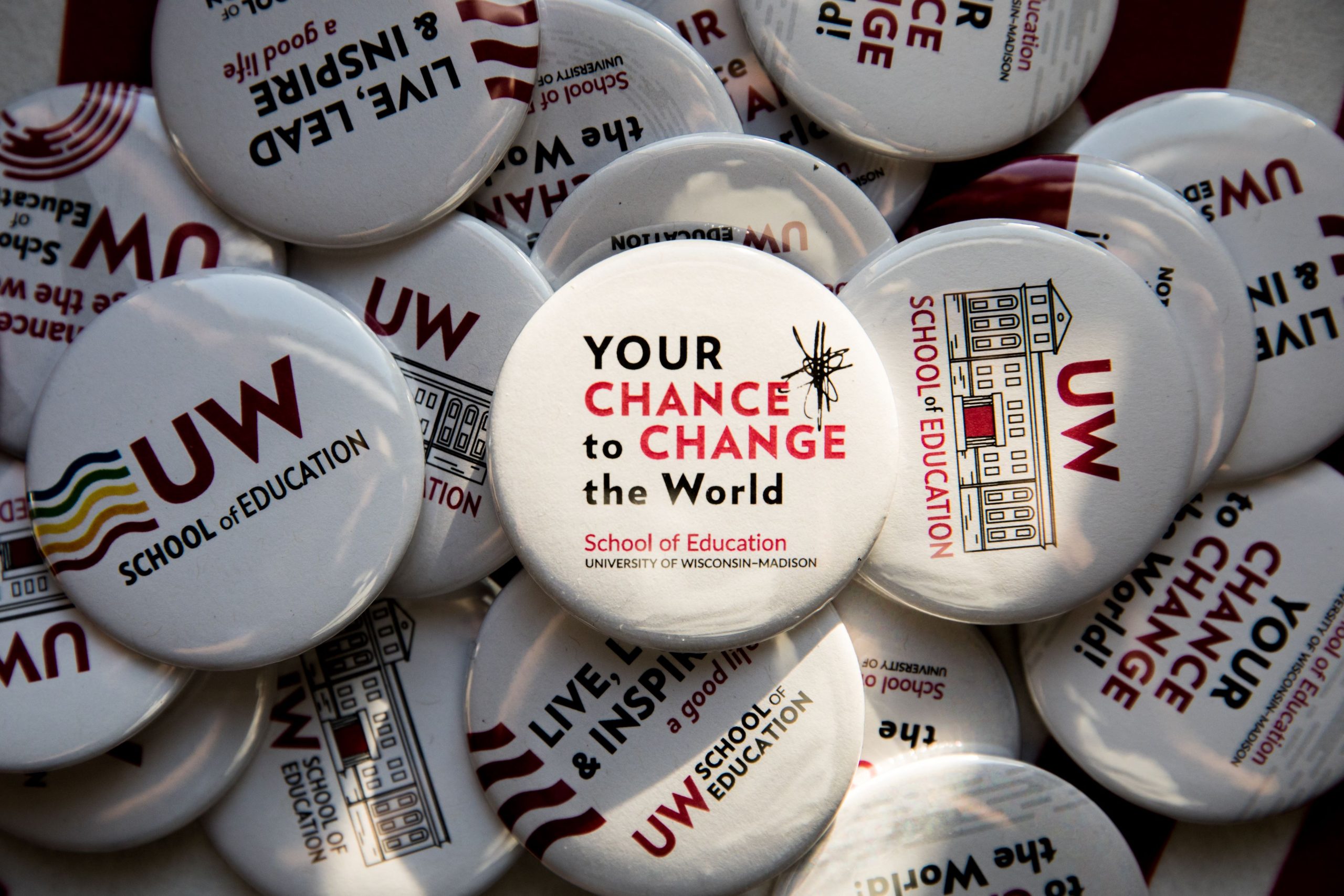 Several UW-Madison Buttons including buttons saying "Your Chance to Change the World" "UW School of Education"