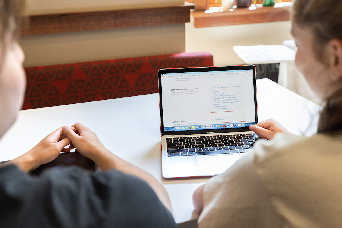 two students working on a computer