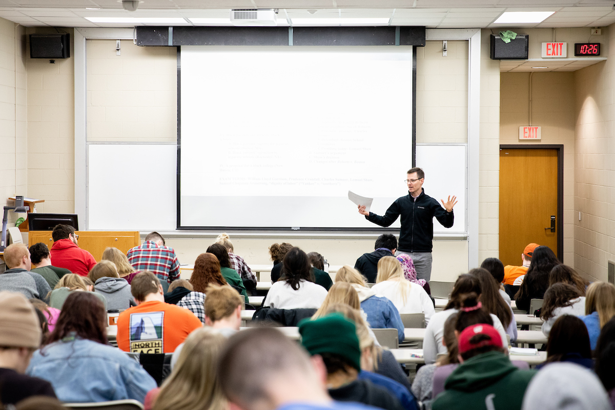 Adam Nelson teaching students in a classroom