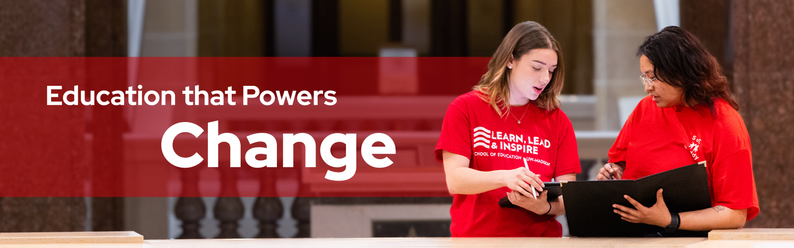Two University of Wisconsin Students chatting at the capital with the words Education that Powers Change in the background