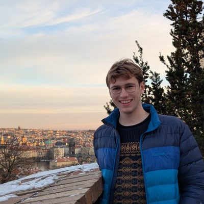 Medium Shot of undergraduate student and EPS major Will Bush in front of a city.