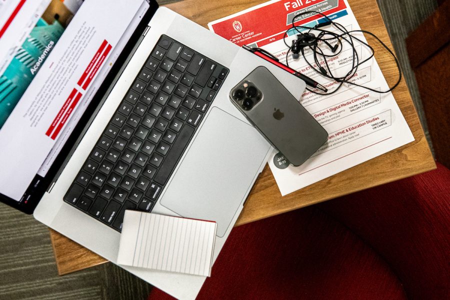 overhead of a computer, phone, and headphones