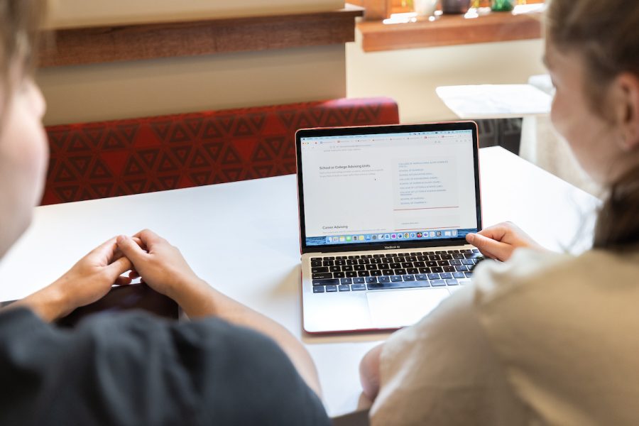 two students working on a computer
